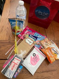 various items are sitting on the floor next to each other, including water and snacks