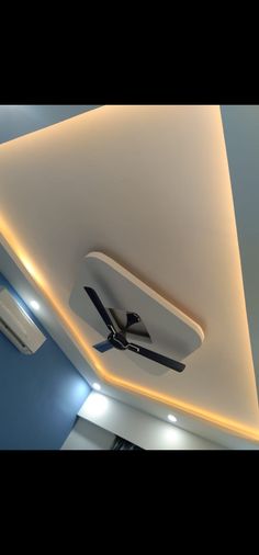 a ceiling fan mounted to the side of a wall