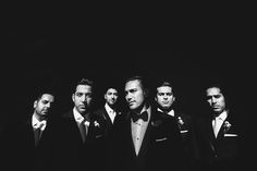 black and white photograph of men in tuxedos