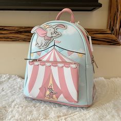 -Authentic, Brand New With Tags Loungefly Disney Dumbo Circus Tent Mini Backpack - This Item Is Sold Out On Site! -You Will Receive The Exact Bag Pictured. -Super Cute, A Fantastic Piece To Take To The Parks Or Even As An Everyday Bag! :) -Comes From A Clean, Smoke Free, Pet Free Home. -I Ship Within 1-2 Days From Purchase. -Please Request For More Photos If Needed. -Check Out My Other Items! Bundle To Save On Shipping. Cute Standard Backpack For Theme Parks, Cute Standard Backpack For Theme Park, Playful Backpack For Theme Park, Themed Red Travel Bag, Loungefly Disney Backpack, Pikachu Halloween Costume, Disney Loungefly Backpack, Pikachu Halloween, Little Mermaid Characters