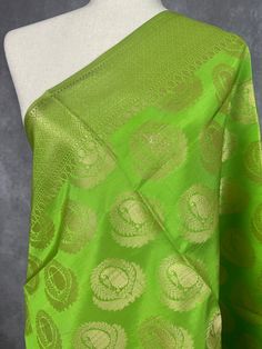 a green and gold sari with intricate designs on it