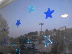 some blue stars are hanging in the window