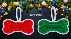 two crocheted dog bone ornaments hanging from a christmas tree