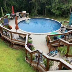 an above ground pool surrounded by deck chairs and umbrellas