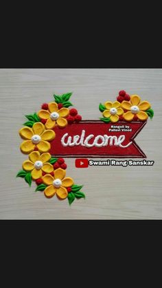 the welcome sign is decorated with yellow and red flowers