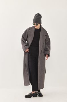 A heavy weight longline rode coat. An oversize fit with long voluminous sleeves and side pockets. Features a lapel collar with an embroidered logo. Comes with a detachable waist belt. A cozy worm coat you can wear over any outfit.  100% Polyester Color: Black tone fishbone﻿ Care: Dry clean only Oversize fit, take your Long Winter Outerwear With Belted Cuffs, Oversized Outerwear With Belted Cuffs For Fall, Oversized Long Belted Outerwear, Oversized Long Coat With Belted Cuffs, Modern Oversized Long Coat, Oversized Belted Outerwear With Lapel Collar, Oversized Long Wool Coat With Pockets, Modern Long Outerwear For Fall, Oversized Chic Outerwear With Belted Cuffs