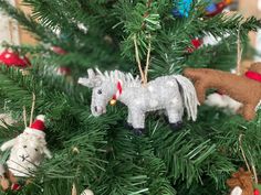 the ornaments on the christmas tree are made to look like horses and santa claus hats