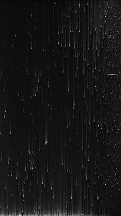 black and white photograph of rain falling down