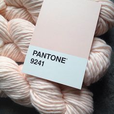 a cell phone with an image of a ball of yarn on it and the text pantone 921