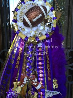 a purple and gold door hanger with a football decoration on it's side