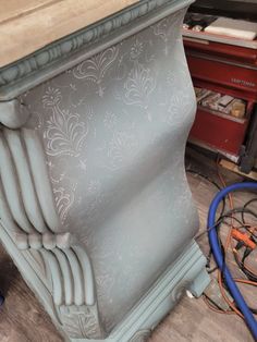 an old dresser is being worked on with some paint