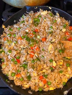 a pan filled with fried rice and vegetables