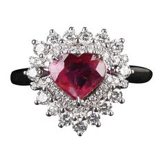 This is a heart shape ruby cluster ring. The ruby is currounded by circles of diamonds, with the inner circle consists of smalle dianonds and the outer layer with significantly larger diamonds. It is a cute design as suited younger generation. It also makes a perfect alternative engagement ring as the younger generation prefers to have colour stones engagement ring rather than the traditional diamond engagement ring. 1.36 CT HEART SHAPE Ruby and Diamond Ring in 18K white gold The Colour of the R Colored Stone Engagement Rings, Dress Reference, The Inner Circle, Ruby And Diamond Ring, Alternative Engagement Ring, Traditional Diamond, Inner Circle, Heart Shaped Diamond, Alternative Engagement Rings