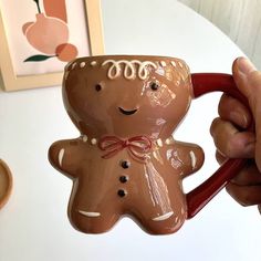 a person holding a mug shaped like a ginger