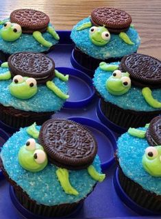 cupcakes decorated with oreo cookies and sea creatures are on a blue tray