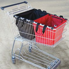 two shopping carts sitting side by side on the ground, one has a red bag in it