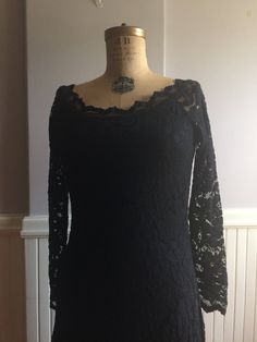 "Black Stretch lace dress that sits right on the shoulder with a beautifully designed neckline. Made in Canada, under the label Joseph Ribkoff. Tag inside indicates it's a size 12( Canada, USA, Mexico) size 40(Germany),Size 14(UK),size 42,(France). Fabric content, 71% nylon, 26% rayon, 3% spandex, 100% polyester lining. The great attribute of this dress is you can hand wash in cold water, dry flat! No dry cleaning, no unnecessary chemicals. Lines are very flattering and fitted to the body with a Fitted Black Lace Dress For Wedding, Fitted Scalloped Lace For Evening, Fitted Off-shoulder Lace Dress For Formal Occasions, Formal Fitted Off-shoulder Lace Dress, Fitted Lace Bodice For Evening, Fitted Lace For Mother Of The Bride, Fitted Black Lace Top With Lace Sleeves, Black Fitted Lace Top With Lace Sleeves, Fitted Black Lace With Sleeves