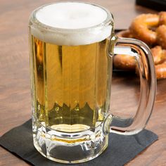 a mug of beer and some doughnuts on a table