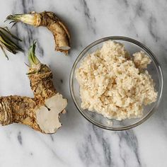 some food is laying out on a marble counter top and next to it's cut up root