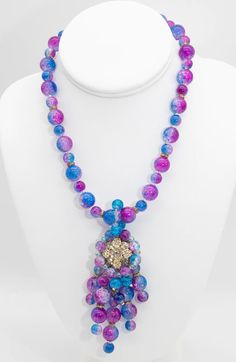 "It is very difficult to find this French glass because it involves several colors and they are heated in such a way that it causes lines in the glass. This unusual piece combines both purple and blue.  In-between the beads are a gold tone beads.  The centerpiece is 3-3/4\" long with a rhinestone flower in the center. The necklace has a hook clasp and is signed \"Anka\". It is a one-of-a-kind necklace, so you can wear it with confidence as an original with no one else wearing it." Purple Glass Beads For Jewelry Crafting, Purple Glass Jewelry For Jewelry Making, Purple Glass Beaded Jewelry, Multicolor High Luster Round Bead Jewelry, Multicolor High Luster Round Beaded Jewelry, Purple Beaded Glass Jewelry, Dog Charm Bracelet, French Glass, Faux Pearl Earrings