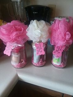 three jars filled with pink and white flowers