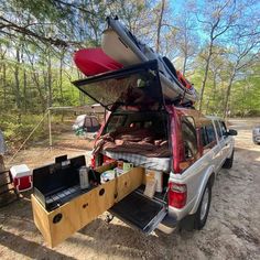 the back end of a pickup truck with an open trunk on it's bed