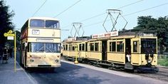 two yellow trolleys are on the tracks next to each other