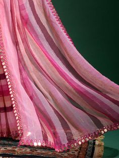 Feel beautiful and elegant in our excellent pink lehriya print chiffon festival wear saree with a blouse! This 5.50-meter-long saree is made from smooth chiffon material and features a lehriya print with zari work and a double-line mirror outing border. The golden plain blouse is embellished with a smooth material for added style. Perfect for festivals, events, or casual occasions, the saree comes with an stitched 1.00-meter blouse. Pink Organza Anarkali Set With Unstitched Blouse, Pink Floor-length Pre-draped Saree With Dori Work, Pink Floor-length Dupatta With Cutdana, Pink Floor-length Blouse Piece With Sheer Dupatta, Pink Floor-length Pre-draped Saree With Cutdana, Pink Organza Floor-length Saree, Pink Floor-length Organza Saree, Pink Semi-stitched Floor-length Pre-draped Saree, Pink Floor-length Saree With Dori Work