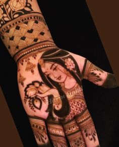 a woman's hand painted with henna