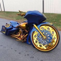 a blue and gold motorcycle parked on the street