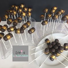 there are many chocolate covered lollipops on the table