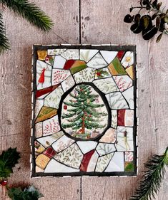 a stained glass christmas ornament with a pine tree on it