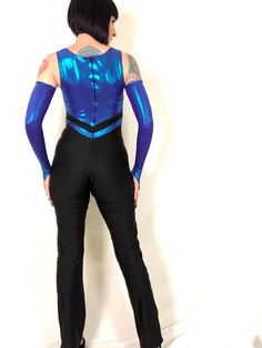 "Vintage 80s 90s Blue Purple Metallic Iridescent Lamé Dance Costume Jumpsuit! Features: - one piece stretchy spandex jumpsuit - top is composed of blue-purple iridescent metallic lamé - stretchy black spandex bottoms - back nylon zipper - 2 of these in stock; one comes with the matching gauntlet gloves, the other does not (price is reflected) Excellent condition! Bust: 30\"- 36\" Waist: 27\"+ Hips: 36\"- 40\" Rise: 23.5\" Inseam: 35\" Length: 57\"- 58\" Model is 5' 9\" and measures 33-27-39. Acc Disco Fitted Bodysuit For Costume Party, Disco Style Fitted Bodysuit For Costume Party, Stretch Rave Unitard For Costume Party, Rave Style Stretch Unitard For Costume Party, Stretch Dancewear Bodysuit For Costume Party, High Stretch Blue Bodysuit For Party, Blue Stretch Unitard For Costume Party, Blue Dance Bodysuit, Blue Fitted Dancewear Bodysuit