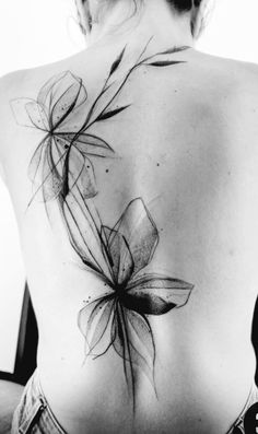 a woman's back with flowers on it