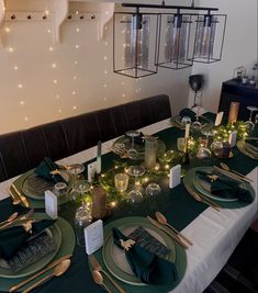 the table is set with green plates and silverware