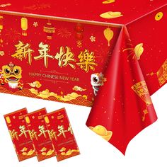 a red table cloth with chinese new year greetings on it and three small packets