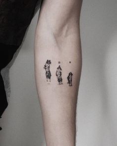 a person's leg with three small dogs on it and one is in the shape of a heart