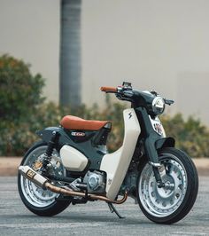 a white and black motorcycle parked in a parking lot