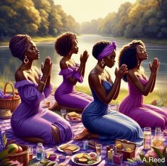 three black women sitting on a blanket in front of a lake with food and drinks