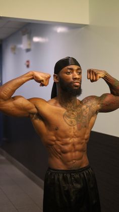 a man flexing his muscles in an office hallway