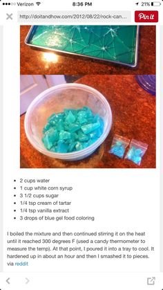 a bowl filled with blue and green rocks on top of a wooden table next to a tray