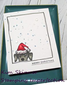 a christmas card with a dog wearing a santa hat