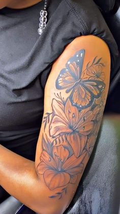 a woman with a butterfly tattoo on her arm