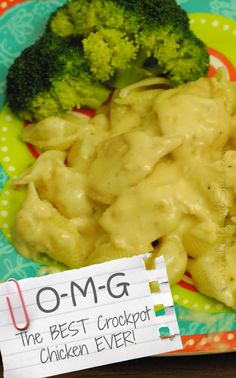 a plate with broccoli and some kind of food on it next to a sign that says om - g