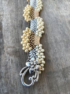 "I wanted to create some pieces that reflected how I feel about Snow, holidays and Winter. This is a custom, original design by Sonserae Designs. I love choosing the colors first...All the things that remind me of transitioning to Winter and the Holidays. All the beads are high quality Japanese Glass beads of various sizes. It's a great, unique gift for the holidays or any special occasion...hand beaded by me with love and care. I'm also able to make it in different colors if you prefer. I hope Handmade Gold Beaded Bracelets As Gifts, Handmade Gold Beaded Bracelets For Gifts, Handmade Cream Pearl Bracelet Gift, Unique Bracelets With Spacer Beads For Gift, Silver Beaded Bracelets With Unique Variations, Unique Handmade Gold Beaded Bracelets, Elegant Handmade Beige Beaded Bracelets, Artisan Silver Beaded Bracelets With Unique Variations, Handmade Fusion Style Beaded Bracelets As Gift