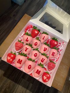 a box filled with chocolate covered strawberries and the words i love you written on them