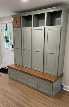 a room that has some cupboards on the wall and wood flooring in it