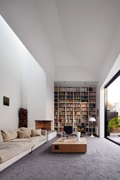 a living room filled with furniture and bookshelves