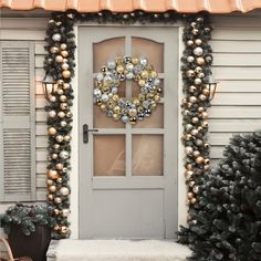 a front door decorated for christmas with ornaments