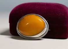 "Vintage Sterling Silver Cabochon 28mm Egg Yolk Amber Pin Brooch - C Clasp 10.1g The early silver pin tested as sterling silver. Nice chunky Egg Yolk amber free form stone. There is a hallmark on the pin section Brooche's size is 1 1/4\" by 1 1/8\"" Oval Cabochon Brooches For Anniversary, Classic Cabochon Brooches For Gifts, Classic Cabochon Brooches As Gift, Classic Oval Cabochon Brooches, Classic Oval Brooches For Collectors, Classic Oval Silver Brooches, Silver Hallmarked Oval Brooch, Silver Hallmarked Oval Brooches, Silver Oval Hallmarked Brooch